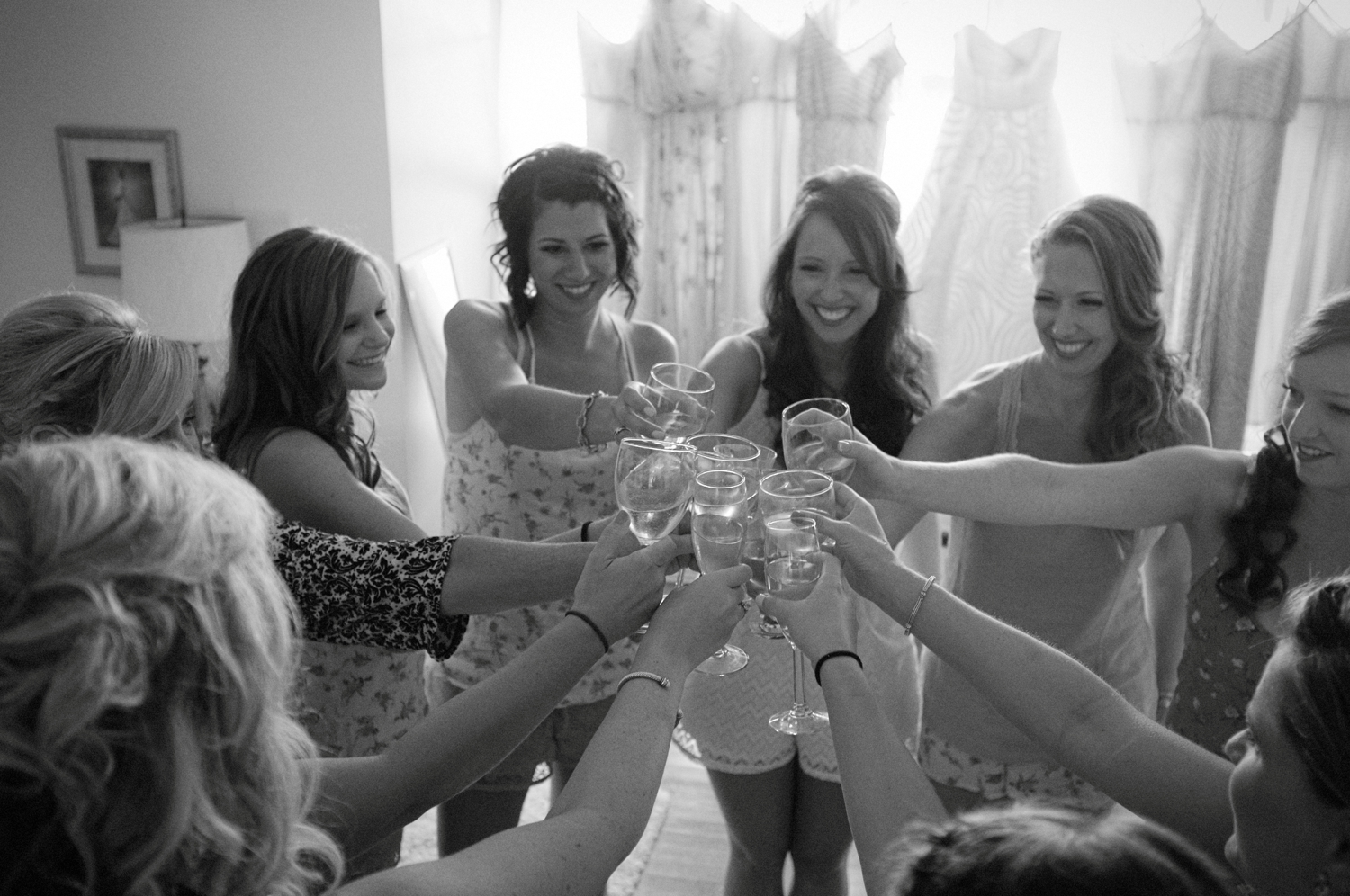 bride and bridesmaids toasting mimosas champagne