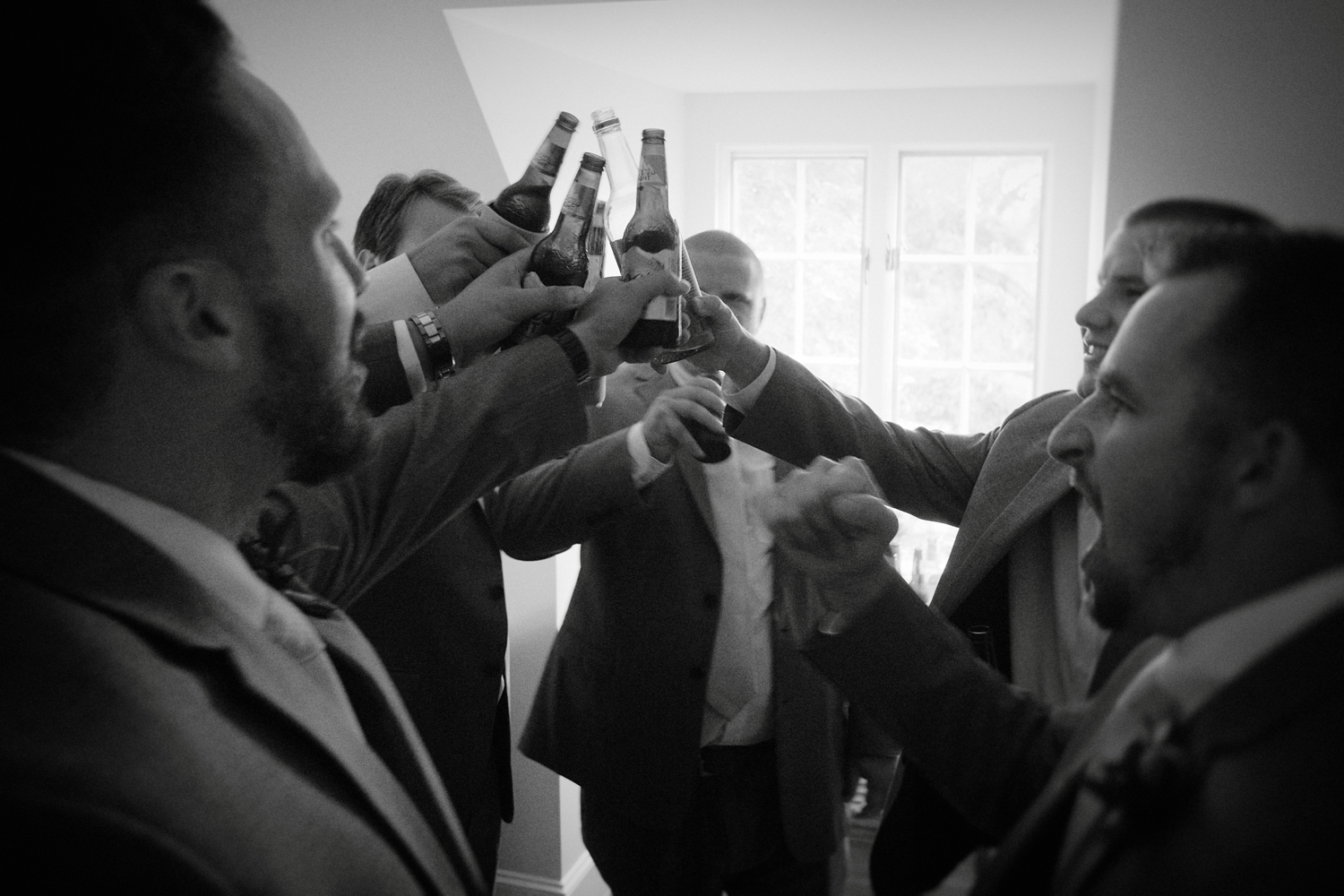 groomsmen toasting black and white